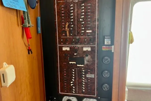 Slide: The Image of Electrical panel inside a 2003 Silverton 43 Motor Yacht, featuring various switches and gauges. - 30