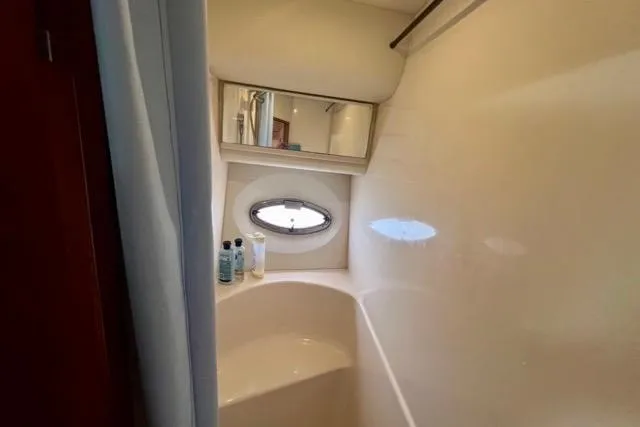 Slide: The Image of Bathroom interior of 2003 Silverton 43 Motor Yacht with porthole and toiletries. - 33