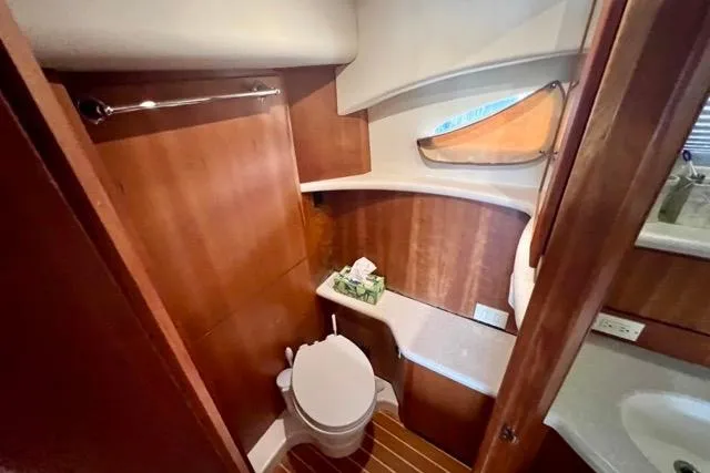 Slide: The Image of 2003 Silverton 43 Motor Yacht bathroom with wooden cabinetry and modern fixtures. - 38