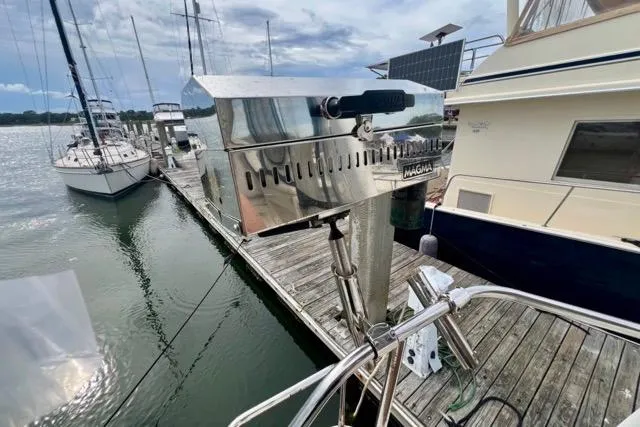 Slide: The Image of 2003 Silverton 43 Motor Yacht docked with stainless steel grill on deck. - 4