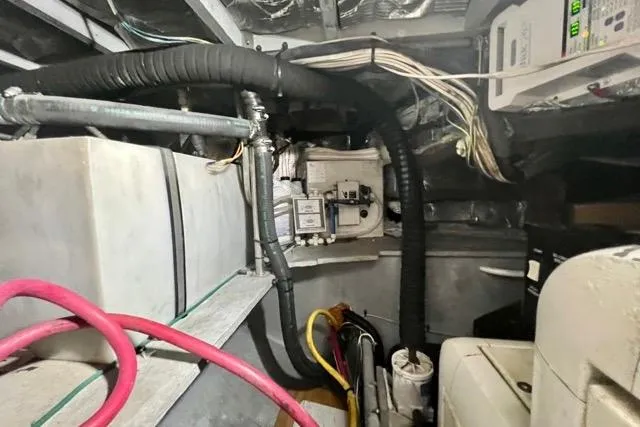 Slide: The Image of Engine room of a 2003 Silverton 43 Motor Yacht with visible wiring and equipment. - 43