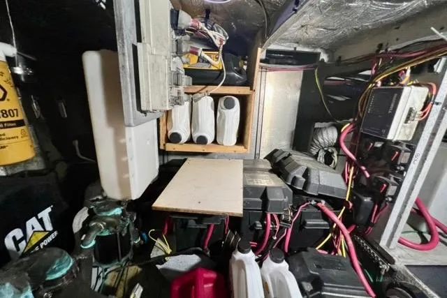Slide: The Image of Engine room of a 2003 Silverton 43 Motor Yacht with various equipment and wiring. - 45
