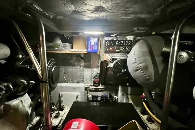 Slide: The Image of Engine room of a 2003 Silverton 43 Motor Yacht, showcasing mechanical components and storage. - 51
