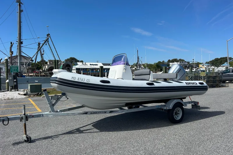 Slide: The Image of 2016 Brig Navigator 520 inflatable boat on trailer at marina. - 1