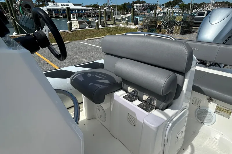 Slide: The Image of Interior of a 2016 Brig Navigator 520 boat, featuring a sleek steering wheel and cushioned seating. - 10