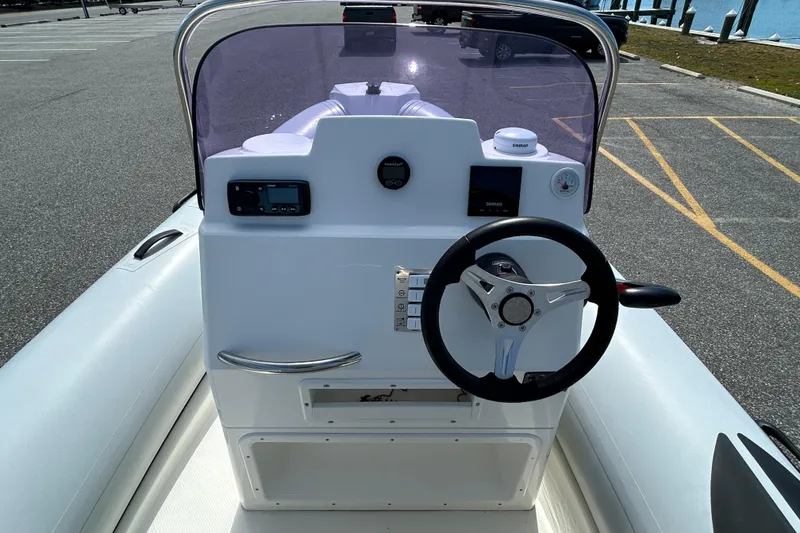 Slide: The Image of 2016 Brig Navigator 520 boat dashboard with steering wheel and controls. - 15