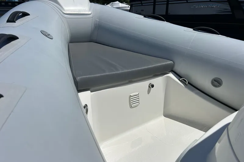 Slide: The Image of 2016 Brig Navigator 520 inflatable boat interior with cushioned seating and storage area. - 16