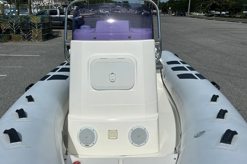 Slide: The Image of 2016 Brig Navigator 520 inflatable boat with central console and seating, parked on asphalt. - 19
