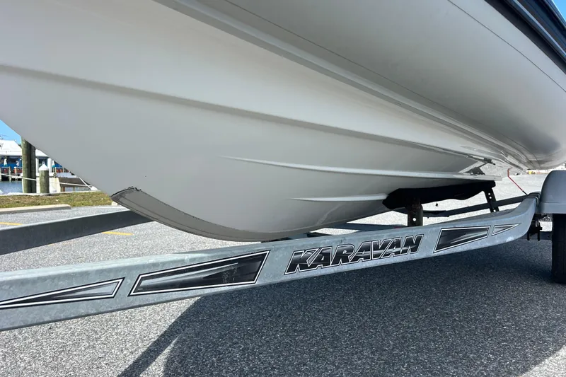 Slide: The Image of 2016 Brig Navigator 520 boat on Karavan trailer, parked on asphalt. - 2