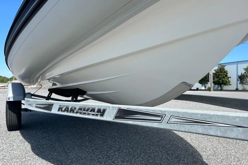 Slide: The Image of 2016 Brig Navigator 520 boat on Karavan trailer, parked on asphalt. - 4
