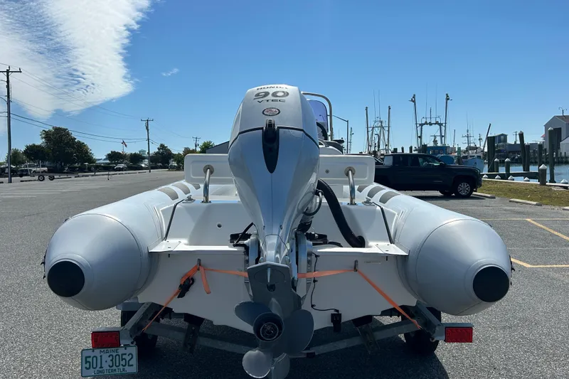 Slide: The Image of 2016 Brig Navigator 520 boat with Honda 90 VTEC engine, parked near a marina. - 6