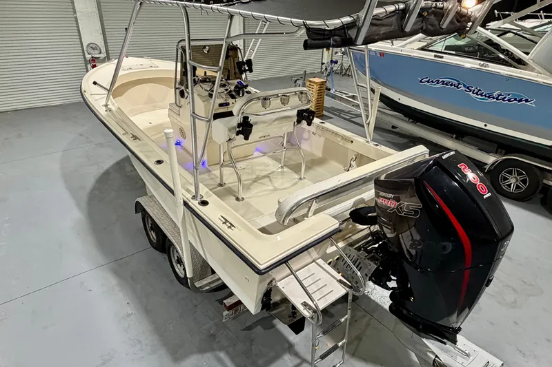 The Image of 2002 Parker 2100 Special Edition boat with Mercury Pro XS engine in a garage setting. - 0