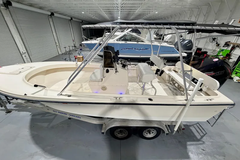 Slide: The Image of 2002 Parker 2100 Special Edition boat in a garage, on a trailer, with a T-top. - 11