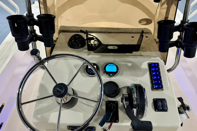 Slide: The Image of Center console of a 2002 Parker 2100 Special Edition boat with steering wheel and controls. - 15