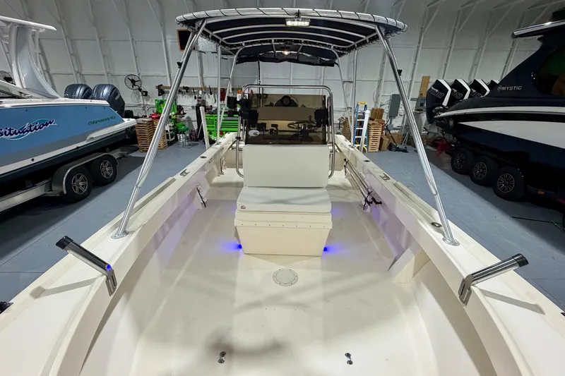 Slide: The Image of 2002 Parker 2100 Special Edition boat in a storage facility, featuring a center console and T-top. - 16