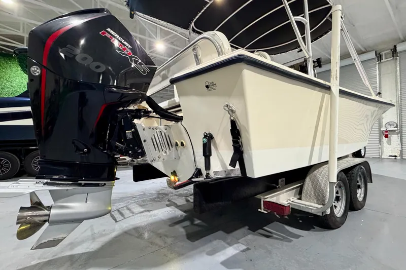 Slide: The Image of 2002 Parker 2100 Special Edition boat with Mercury 200 XS engine on trailer in garage. - 19