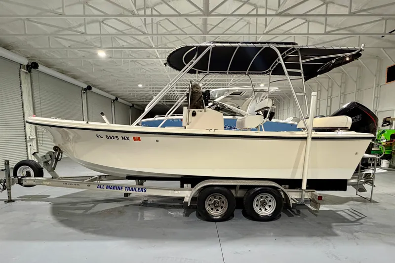 Slide: The Image of 2002 Parker 2100 Special Edition boat on trailer in indoor storage facility. - 2