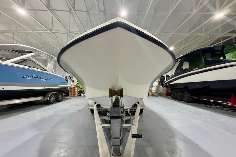 Slide: The Image of 2002 Parker 2100 Special Edition boat in storage, surrounded by other vessels. - 21