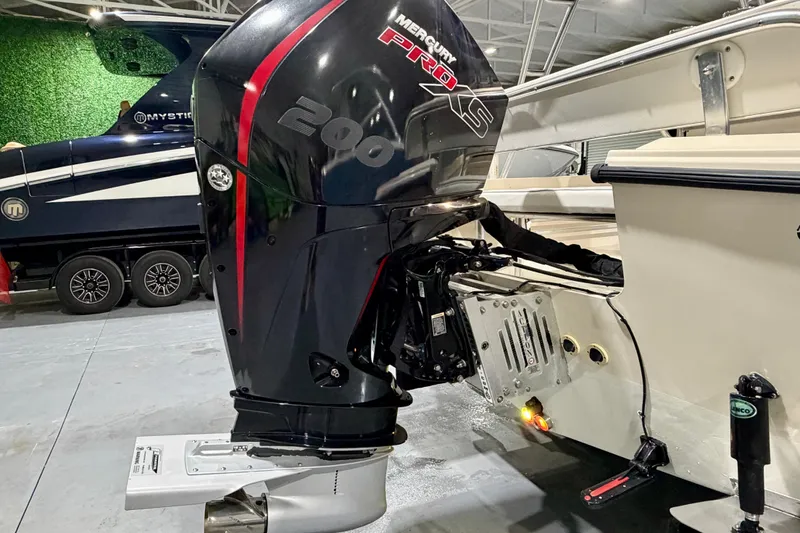 Slide: The Image of Outboard motor on a 2002 Parker 2100 Special Edition boat in a showroom. - 22