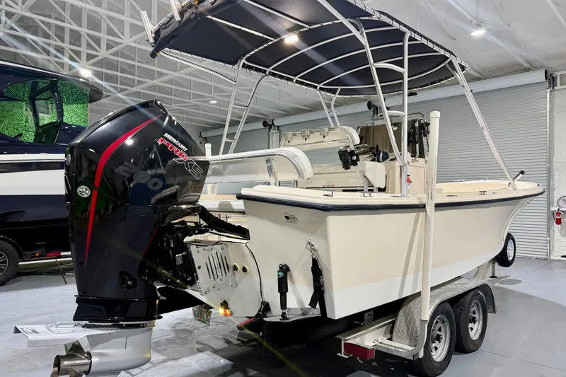 Slide: The Image of 2002 Parker 2100 Special Edition boat with Mercury Pro XS engine on a trailer in a showroom. - 4