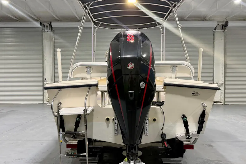 Slide: The Image of 2002 Parker 2100 Special Edition boat with powerful outboard motor in a garage setting. - 5
