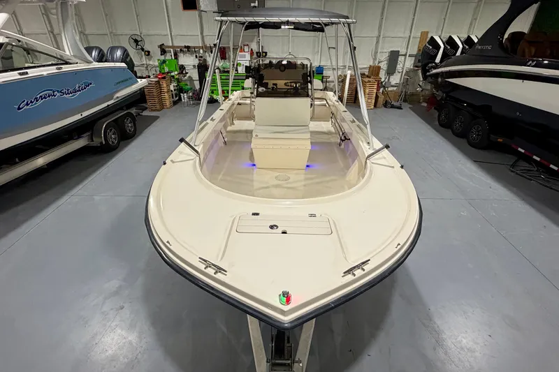 Slide: The Image of 2002 Parker 2100 Special Edition boat in a showroom, featuring a sleek design and spacious deck. - 6