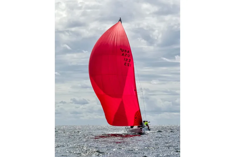 Slide: The Image of Sailing yacht Melges 32 (2005) with vibrant red spinnaker on open water. - 2