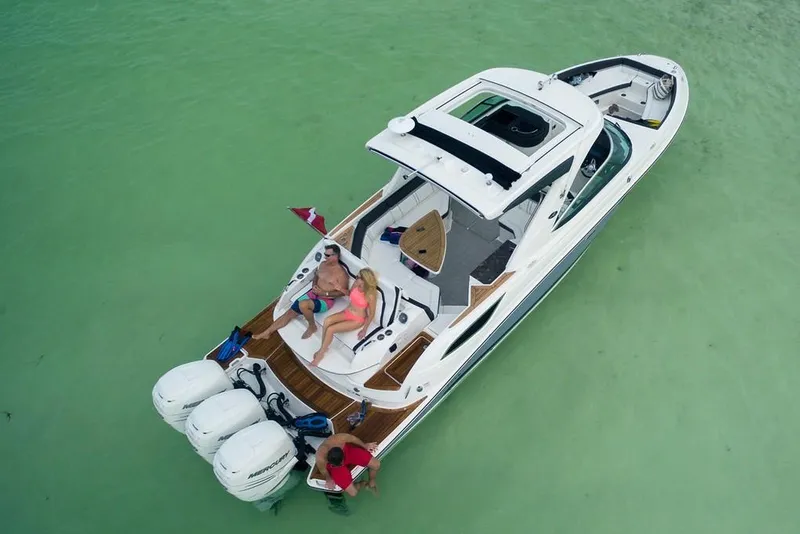 Slide: The Image of Manufacturer Provided Image: 2019 Sea Ray SLX 350 OB boat on clear water with people relaxing. - 5