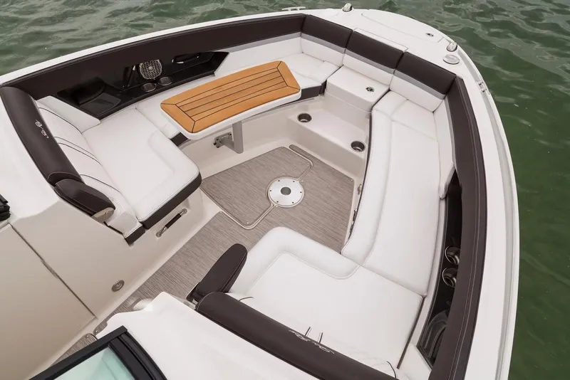 Slide: The Image of Manufacturer Provided Image: 2019 Sea Ray SLX 350 OB boat interior with spacious seating and wooden table. - 7