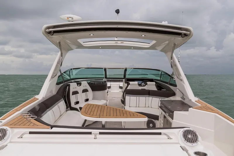 Slide: The Image of Manufacturer Provided Image: 2019 Sea Ray SLX 350 OB luxury boat interior with seating and table on open water. - 12