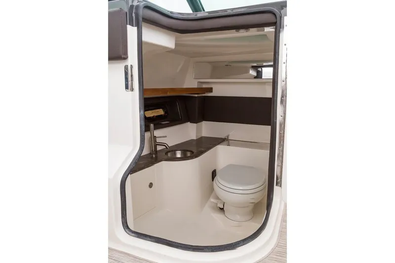 Slide: The Image of Manufacturer Provided Image: 2019 Sea Ray SLX 350 OB boat bathroom with sink and toilet. - 19