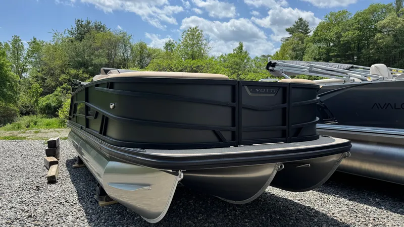 Slide: The Image of Evotti 521CS 2026 pontoon boat parked outdoors. - 2