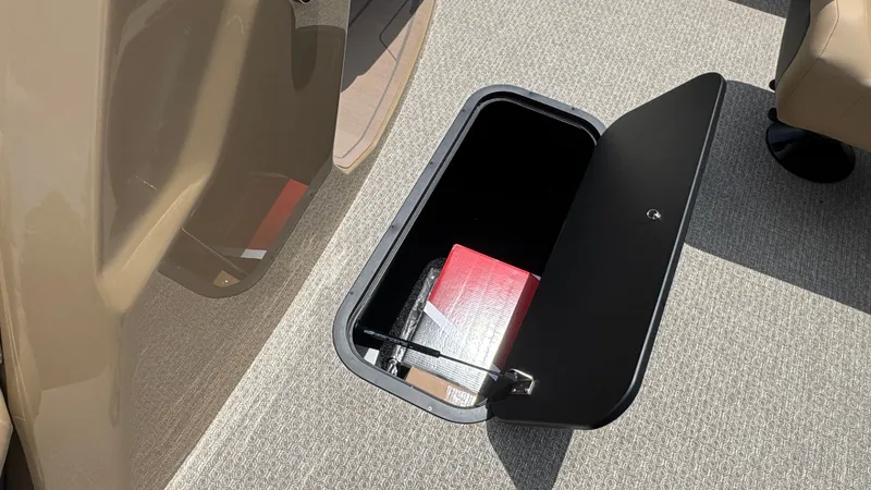 Slide: The Image of Evotti 521CS 2026 floor compartment with open hatch and red box. - 21