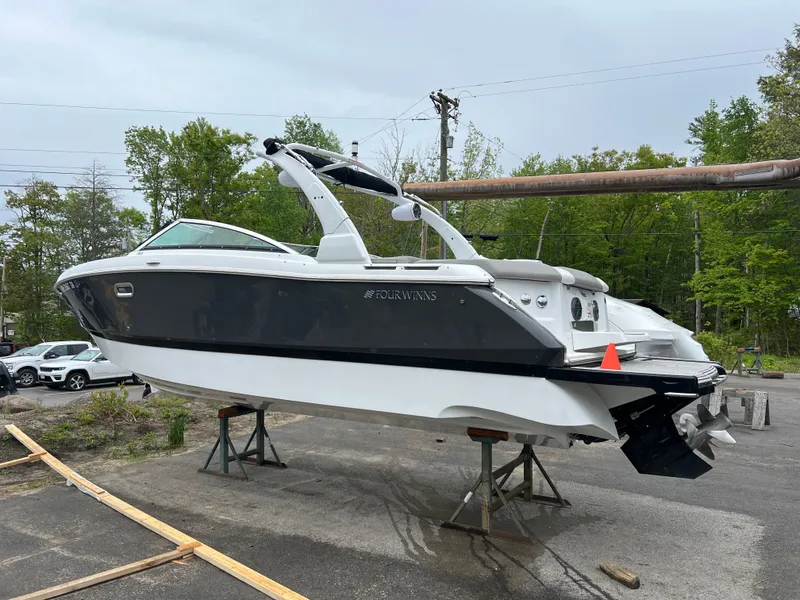 The Image of 2022 Four Winns H260 boat on a trailer outdoors. - 1