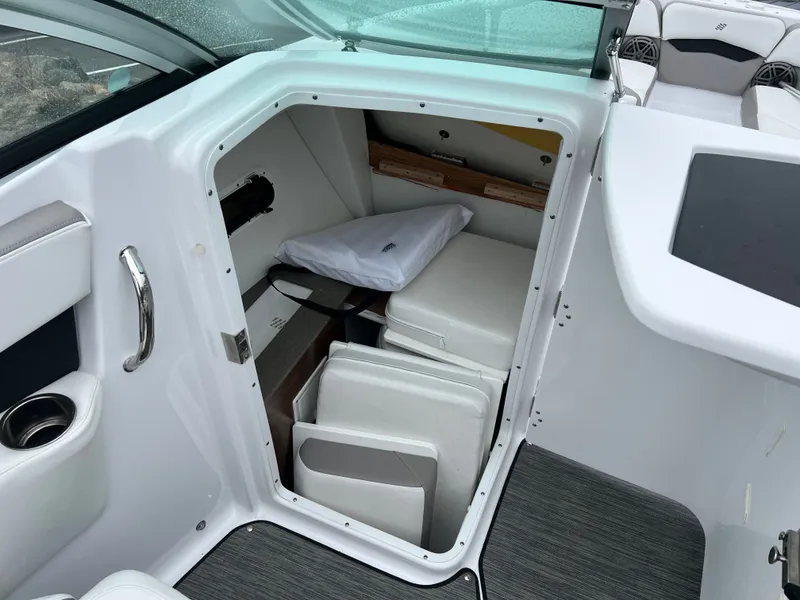 Slide: The Image of Interior of 2022 Four Winns H260 with storage and seating area. - 19
