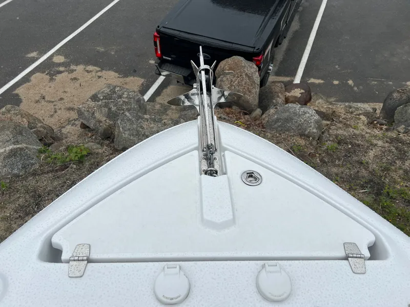 Slide: The Image of Bow of a 2022 Four Winns H260 boat overlooking a parking lot. - 25