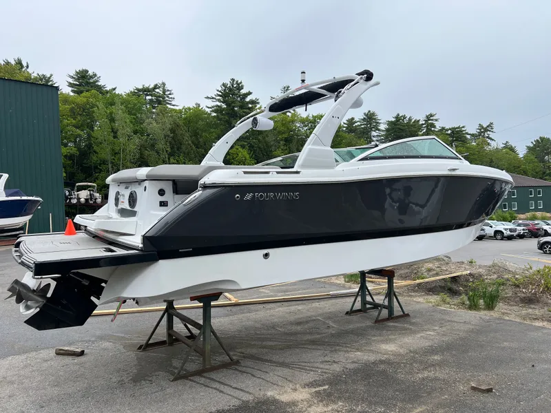 Slide: The Image of 2022 Four Winns H260 boat on stands outdoors. - 3