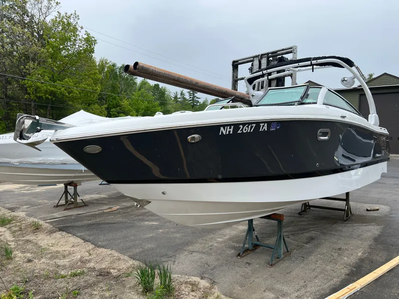 Slide: The Image of 2022 Four Winns H260 boat on a parking lot. - 5
