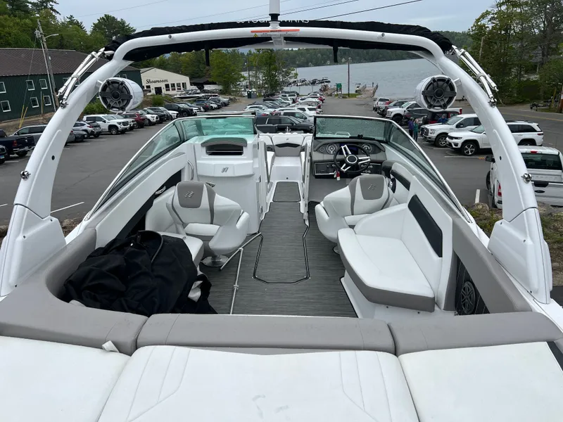 Slide: The Image of Interior view of a 2022 Four Winns H260 boat by the lake. - 6