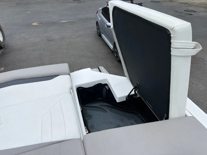 Slide: The Image of 2022 Four Winns H260 boat with open storage compartment lid. - 9
