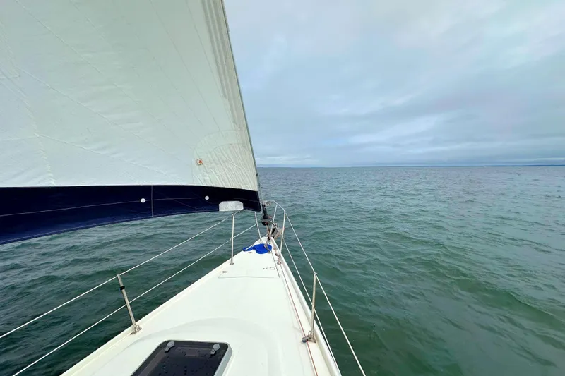 Slide: The Image of Sailing on a 1993 Ericson 38-200 yacht, open sea view, cloudy sky. - 12