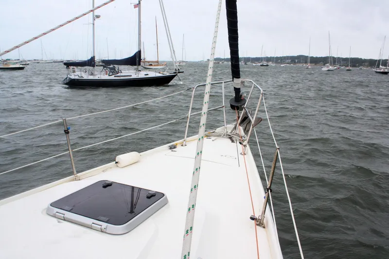 Slide: The Image of Sailing on a 1991 Ericson 380 yacht in a busy harbor. - 13