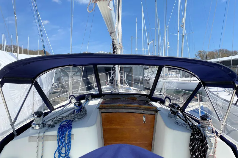 Slide: The Image of 1993 Ericson 38-200 sailboat cockpit with blue canopy and rigging, docked at marina. - 14