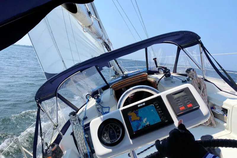 Slide: The Image of Sailing on a 1993 Ericson 38-200 yacht with navigation equipment and clear blue skies. - 16