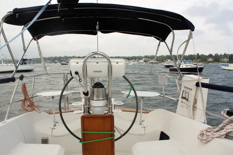Slide: The Image of Cockpit view of a 1991 Ericson 380 sailboat in a marina with overcast skies. - 17