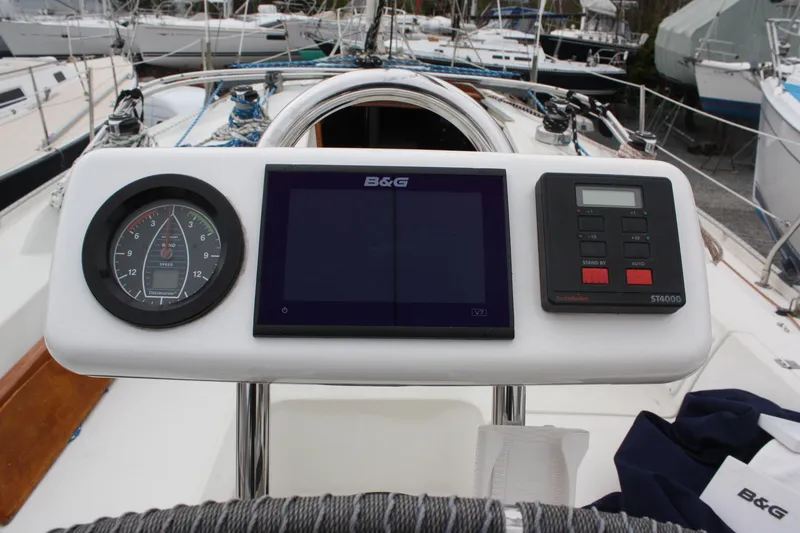 Slide: The Image of Cockpit instruments on a 1993 Ericson 38-200 sailboat, featuring a compass and navigation display. - 18