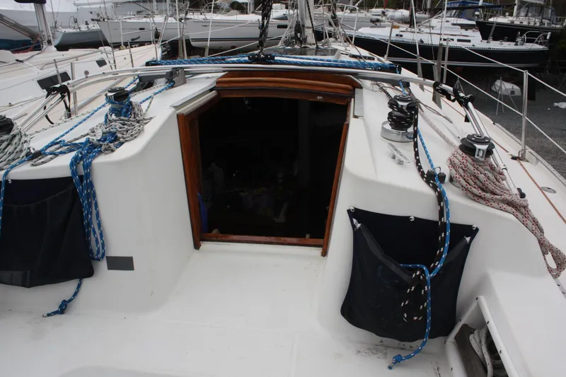 Slide: The Image of Cockpit of a 1993 Ericson 38-200 sailboat with ropes and winches visible. - 19