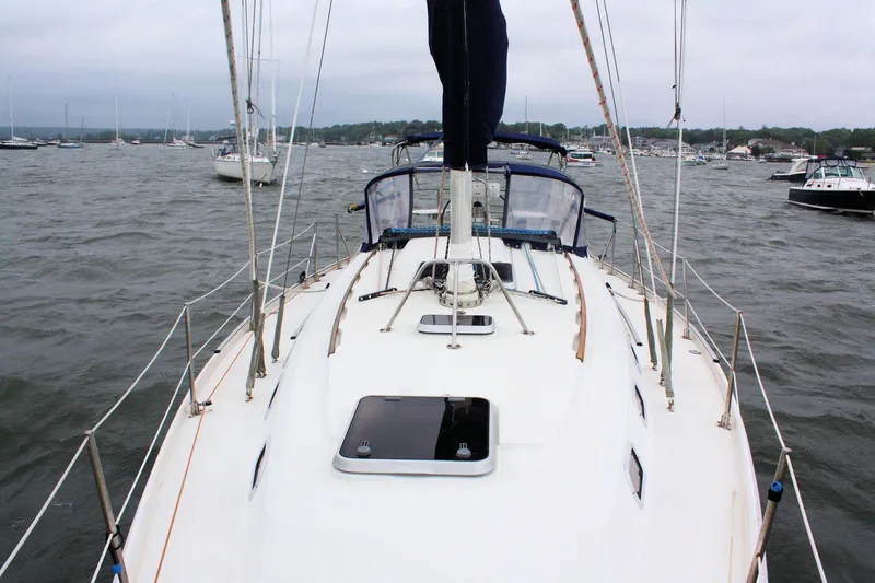 Slide: The Image of Sailing yacht Ericson 380, 1991 model, on a cloudy day in a busy harbor. - 20