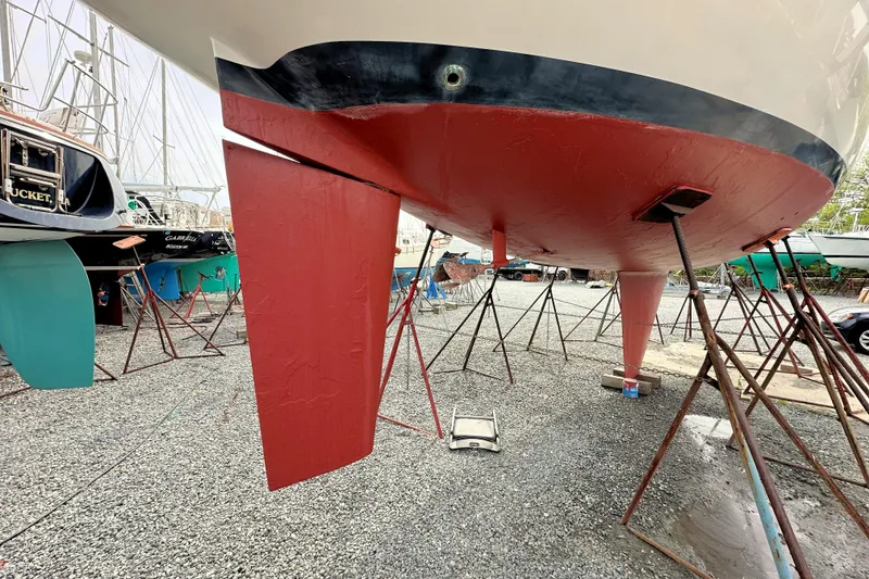 Slide: The Image of 1991 Ericson 380 sailboat hull and keel in dry dock, supported by stands. - 23