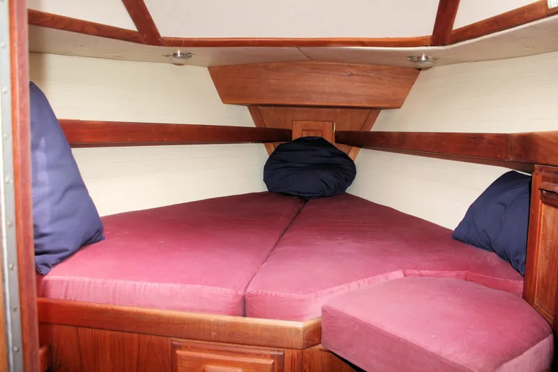 Slide: The Image of Interior cabin of a 1991 Ericson 380 sailboat with red cushions and wooden trim. - 26